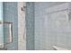Close-up of the shower with blue subway tiles and a shower head at 319 Corrigan Trce, Peachtree City, GA 30269