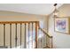 Staircase with decorative wrought iron railing and an ornate light fixture at 319 Corrigan Trce, Peachtree City, GA 30269