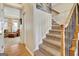 Classic staircase with wood railings and carpeted steps, leading to the upper level of the home, with a view into another room at 319 Corrigan Trce, Peachtree City, GA 30269
