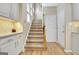 Hallway and stairway with white cabinets and hardwood floors at 319 Corrigan Trce, Peachtree City, GA 30269
