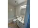 A bathroom with a white vanity, updated fixtures, a mirror and a shower/tub combo at 435 Cedarhurst Rd, Lawrenceville, GA 30045