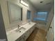 Bathroom with double sink vanity, quartz countertop, and a separate soaking tub, offering a spa-like experience at 435 Cedarhurst Rd, Lawrenceville, GA 30045