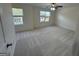 Bright bedroom with plush carpet, a ceiling fan, and large windows offering plenty of natural light at 435 Cedarhurst Rd, Lawrenceville, GA 30045