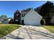 Charming two-story home featuring a brick and vinyl exterior, a two-car garage, and a well-maintained front yard at 435 Cedarhurst Rd, Lawrenceville, GA 30045
