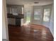 Bright kitchen featuring white cabinets, stainless steel appliances, hardwood floors, and a dining area with natural light at 435 Cedarhurst Rd, Lawrenceville, GA 30045
