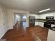 Open-concept kitchen with stainless steel appliances seamlessly flowing into the living space with hardwood flooring at 435 Cedarhurst Rd, Lawrenceville, GA 30045