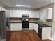 Well-equipped kitchen featuring stainless steel appliances, white cabinets, granite countertops, and a stylish backsplash at 435 Cedarhurst Rd, Lawrenceville, GA 30045