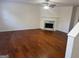 Spacious living room with hardwood floors, a fireplace, and ample space for entertaining guests at 435 Cedarhurst Rd, Lawrenceville, GA 30045