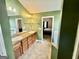 Bathroom features a double sink vanity and a soaking tub, with a view of the bedroom at 9108 Alden Dr, Locust Grove, GA 30248