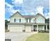 Charming two-story home with a three-car garage and well-maintained lawn at 9108 Alden Dr, Locust Grove, GA 30248