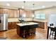 Modern kitchen with granite countertops, a kitchen island with seating and stainless steel appliances at 9108 Alden Dr, Locust Grove, GA 30248
