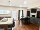 Open-concept kitchen and dining area with stylish island seating, granite countertops and hardwood floors at 9108 Alden Dr, Locust Grove, GA 30248