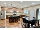 Spacious open-concept kitchen and dining area with hardwood floors and plenty of seating at 9108 Alden Dr, Locust Grove, GA 30248
