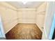 Spacious walk-in closet with carpet floor and several white racks for optimal storage at 9108 Alden Dr, Locust Grove, GA 30248