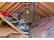 Unfinished attic space ready for storage with exposed rafters, a small window, and insulation at 226 Le Paradis Blvd, Sharpsburg, GA 30277