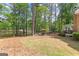 Spacious backyard with lush trees, a view of the lake, and an outdoor dining area at 226 Le Paradis Blvd, Sharpsburg, GA 30277
