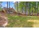 Expansive backyard features lush green lawn, mature trees and a peek at a custom patio area at 226 Le Paradis Blvd, Sharpsburg, GA 30277