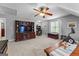 Bright bonus room featuring a ceiling fan, entertainment center, and space for exercise equipment at 226 Le Paradis Blvd, Sharpsburg, GA 30277