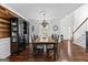 Formal dining room featuring dark wood floors, black furniture, and ample space for hosting guests at 226 Le Paradis Blvd, Sharpsburg, GA 30277