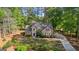 Charming two-story home with mature trees, landscaped yard, and a long driveway at 226 Le Paradis Blvd, Sharpsburg, GA 30277