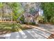 Two-story home with well-maintained landscaping, a concrete driveway, and a private, tree-lined backyard at 226 Le Paradis Blvd, Sharpsburg, GA 30277