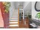 Spacious foyer featuring hardwood floors, a staircase, and an open view into the living and dining areas at 226 Le Paradis Blvd, Sharpsburg, GA 30277