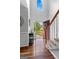 Welcoming foyer featuring gleaming hardwood floors, elegant trim, and a view of the green, tree-filled front yard at 226 Le Paradis Blvd, Sharpsburg, GA 30277
