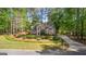 Beautiful two-story home with a red door, surrounded by lush greenery and mature trees at 226 Le Paradis Blvd, Sharpsburg, GA 30277