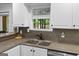Kitchen boasting a picturesque window view and modern fixtures at 226 Le Paradis Blvd, Sharpsburg, GA 30277