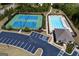 Aerial view of community pool, tennis courts, and recreational facilities in landscaped setting at 7435 Ansley Park Way, Cumming, GA 30028