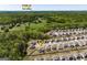Neighborhood aerial view showcases proximity to Publix and surrounding homes and lush green spaces at 7435 Ansley Park Way, Cumming, GA 30028