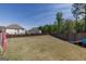 Expansive fenced backyard with ample space for recreation and entertaining on a partially sunny day at 7435 Ansley Park Way, Cumming, GA 30028