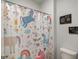 Bathroom featuring a shower with playful unicorn shower curtain and painted wall decor at 7435 Ansley Park Way, Cumming, GA 30028