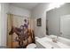 Bathroom featuring a sink and western themed shower curtain at 7435 Ansley Park Way, Cumming, GA 30028