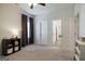 Neutral-toned bedroom with twin bed, view of bathroom, and ample natural light at 7435 Ansley Park Way, Cumming, GA 30028