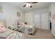 Well-lit bedroom with twin beds, neutral walls, and view of a bathroom at 7435 Ansley Park Way, Cumming, GA 30028