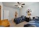 Bedroom featuring two beds, a ceiling fan, and wall decor, plus an ensuite bathroom at 7435 Ansley Park Way, Cumming, GA 30028