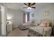 Bright bedroom featuring two wrought iron beds, ceiling fan, and whimsical decor at 7435 Ansley Park Way, Cumming, GA 30028