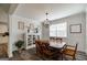 Traditional dining room with a wooden table set, white wainscoting, and modern light fixture at 7435 Ansley Park Way, Cumming, GA 30028