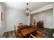 Dining room featuring a wood table set, crown molding, modern lighting, and neutral paint at 7435 Ansley Park Way, Cumming, GA 30028