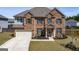 Beautiful two-story home with brick facade, well-maintained lawn, and attached garage at 7435 Ansley Park Way, Cumming, GA 30028