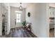 Inviting foyer with wood-look floors, natural light, and access to other rooms at 7435 Ansley Park Way, Cumming, GA 30028