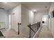 Upstairs hallway with carpet and nice railing at 7435 Ansley Park Way, Cumming, GA 30028