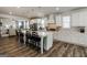 Bright, open kitchen with white cabinets, a large island with seating, and stainless steel appliances at 7435 Ansley Park Way, Cumming, GA 30028