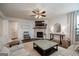 Bright living room features a fireplace, ceiling fan, and comfortable seating at 7435 Ansley Park Way, Cumming, GA 30028