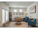 Bright living room featuring a sofa, two chairs, a rug, and neutral paint at 7435 Ansley Park Way, Cumming, GA 30028