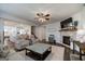 Spacious living room with hardwood floors, a fireplace, and an open layout at 7435 Ansley Park Way, Cumming, GA 30028