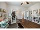 Bright, white room with a long dark wooden table, shelving, and art supplies, showcasing creative space at 7435 Ansley Park Way, Cumming, GA 30028