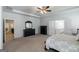 Spacious main bedroom featuring a ceiling fan, ensuite bathroom, and ample space for a dresser at 7435 Ansley Park Way, Cumming, GA 30028