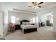 Spacious main bedroom with tray ceiling, neutral carpet, and ensuite bathroom access at 7435 Ansley Park Way, Cumming, GA 30028